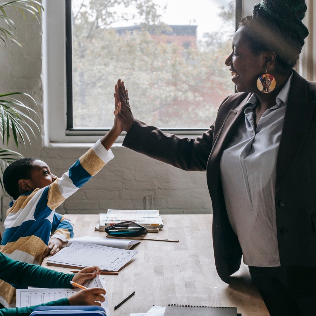 Teacher giving her student a high five